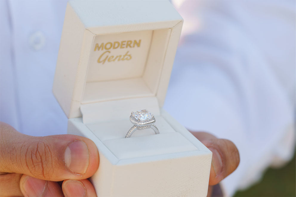 man holding engagement ring in box