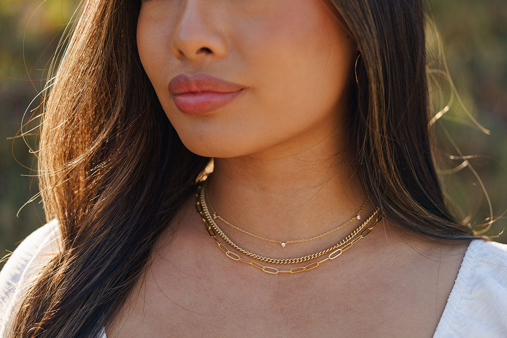 modeling gold layered necklace