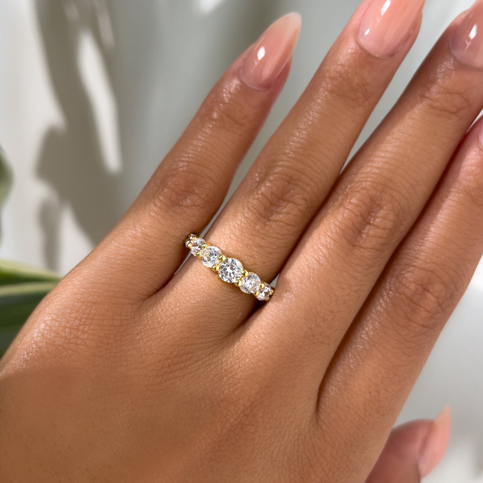 gold bold affordable wedding band on model with neutral nails