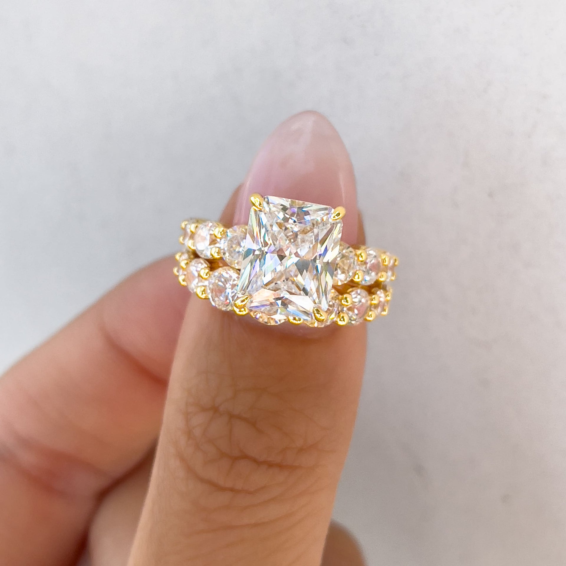 gold bold affordable radiant cut wedding ring set on model with neutral nails