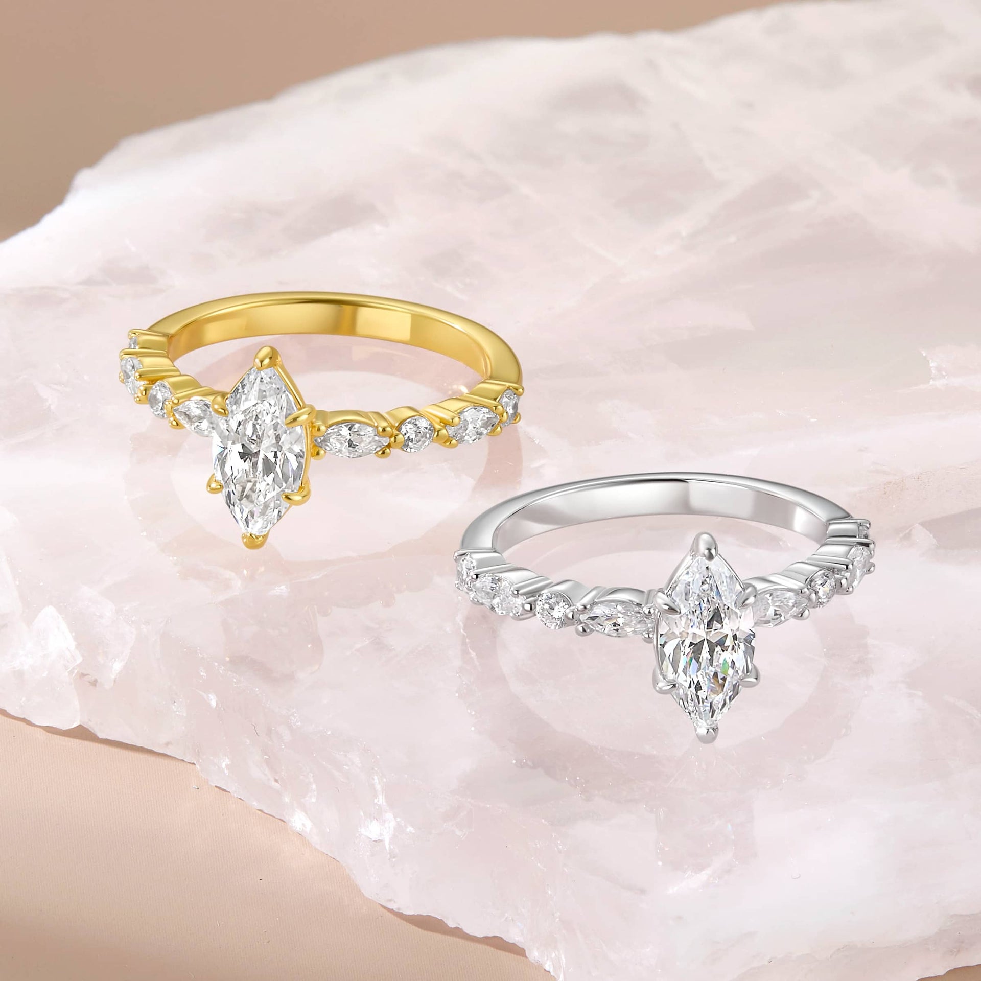 1 carat marquise cut vintage engagement ring shown in gold and silver on a stone-like background