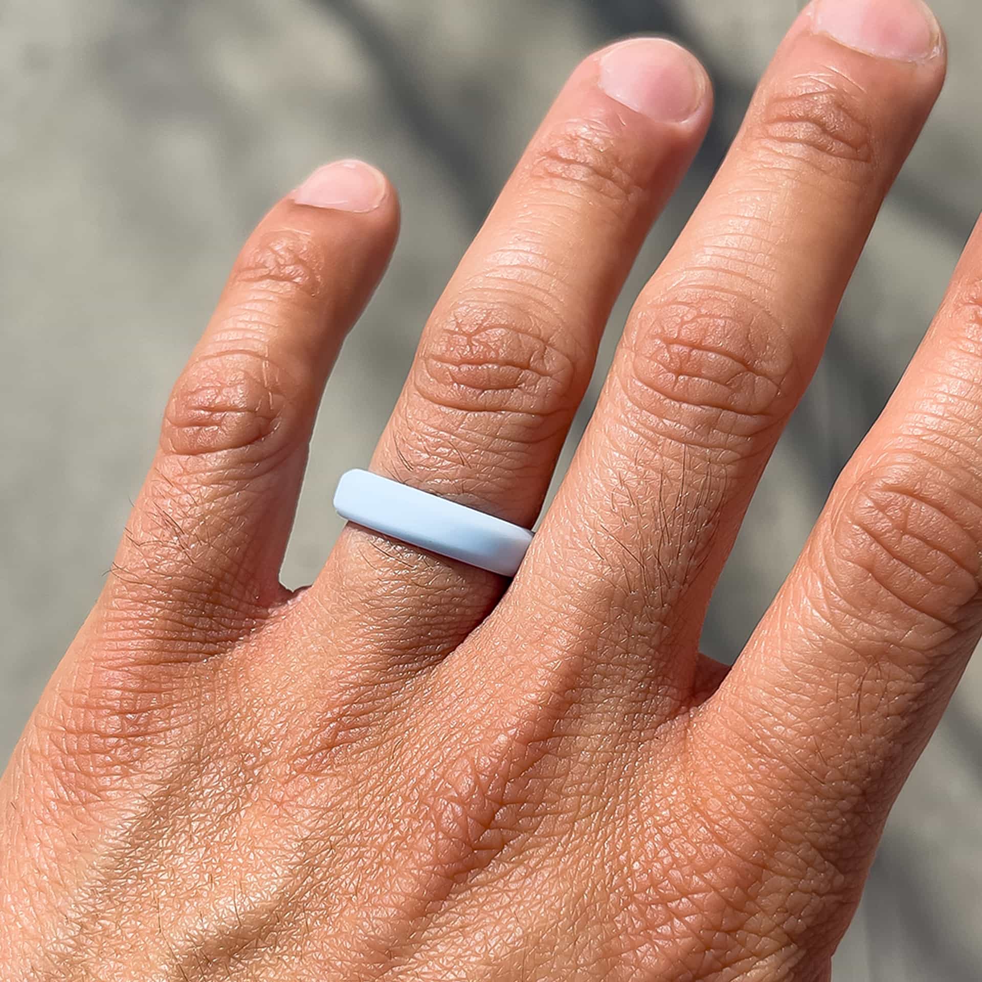 unisex silicone wedding band in sky blue on male model