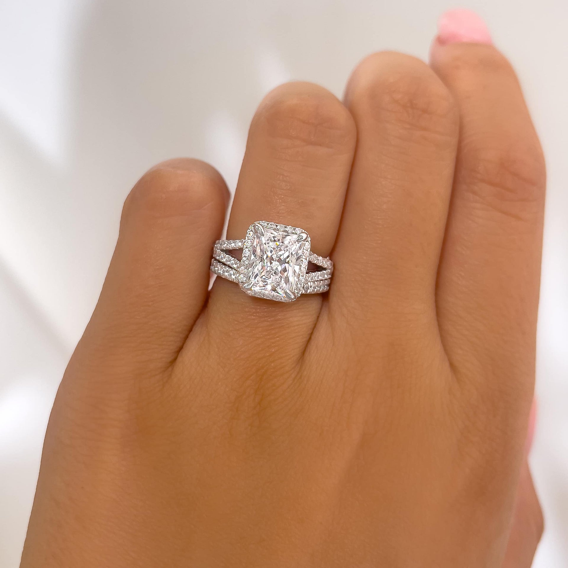 stunning  radiant cut wedding ring set with unique, split half eternity band on ladies hand