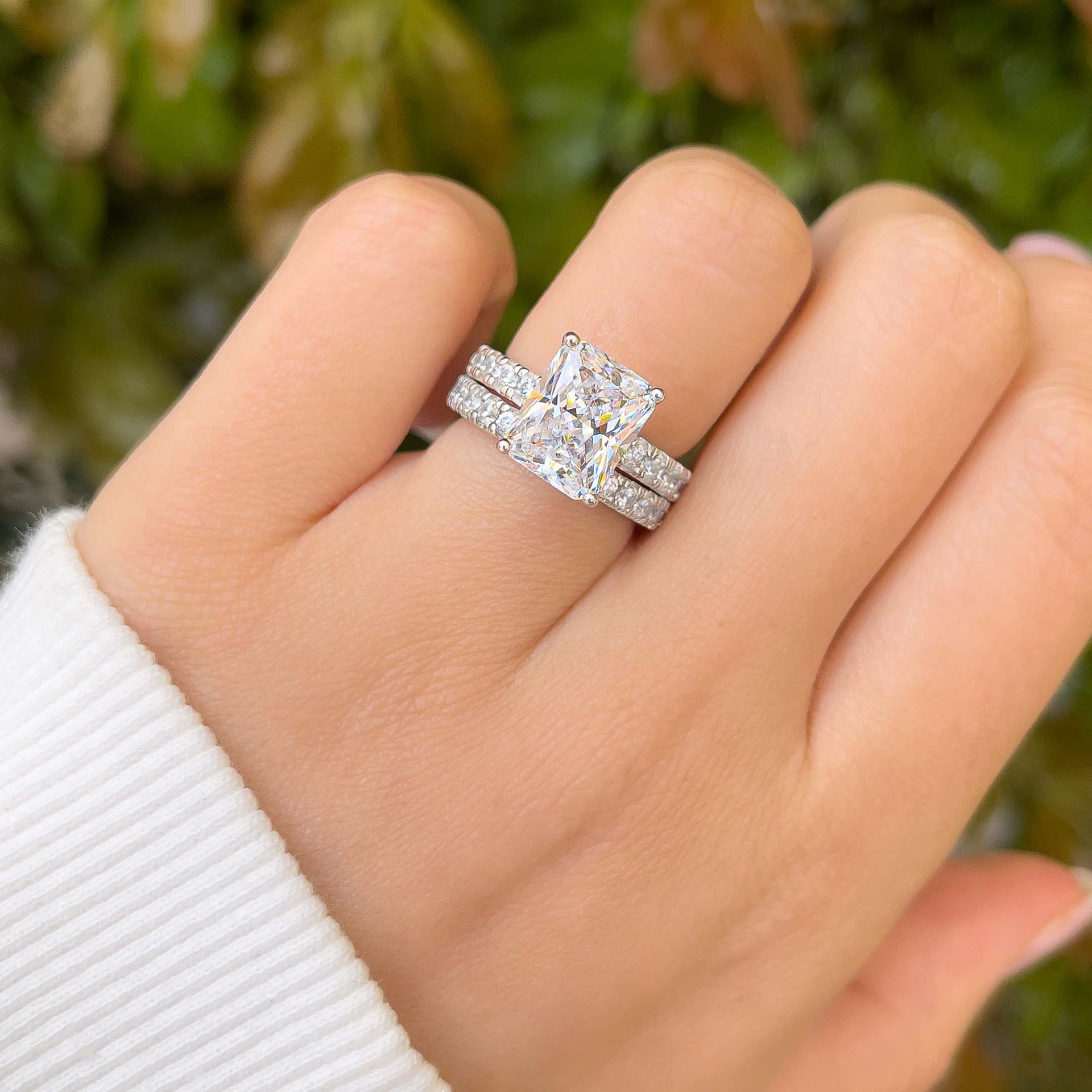 stunning silver 3.75 carat radiant cut wedding set on model with white sleeve