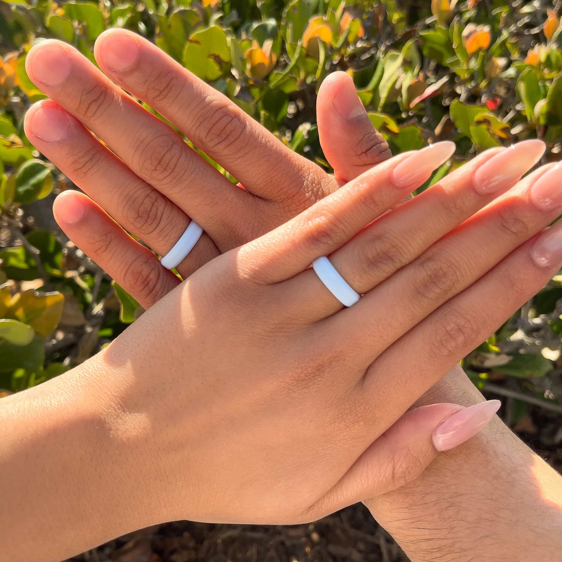 slim unisex silicone wedding band in sky blue worn by male and female model