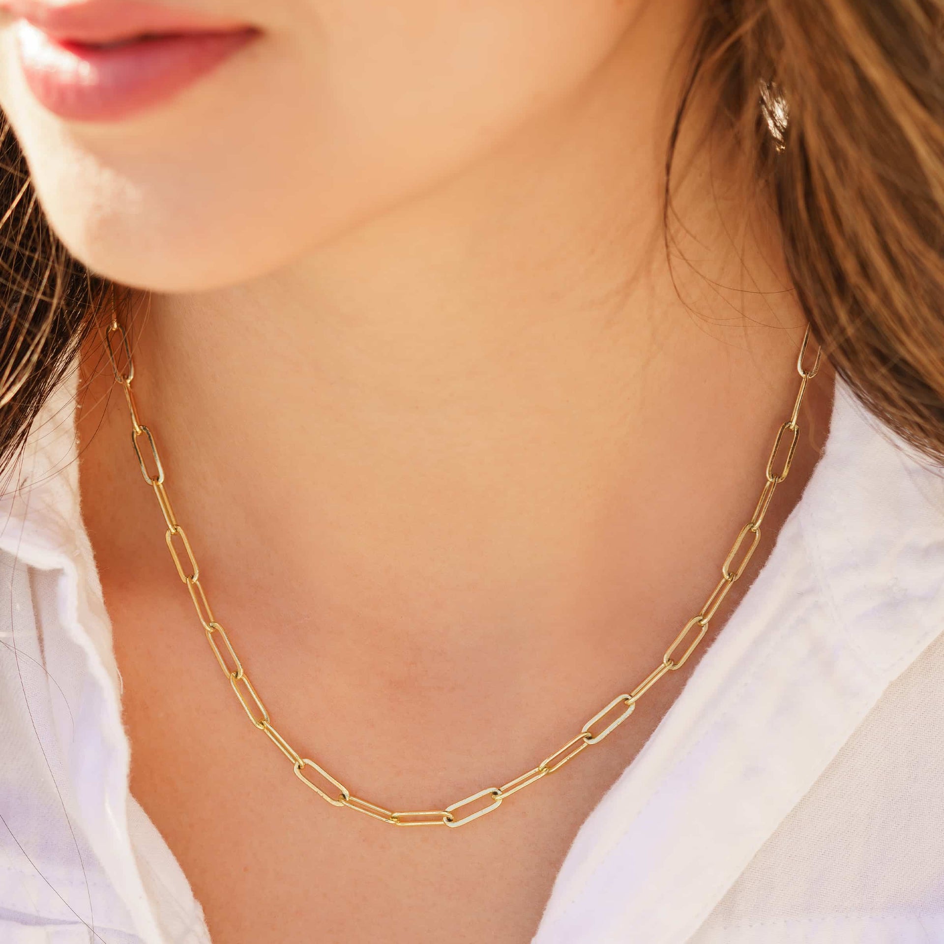 beautiful gold chain necklace on model's neck