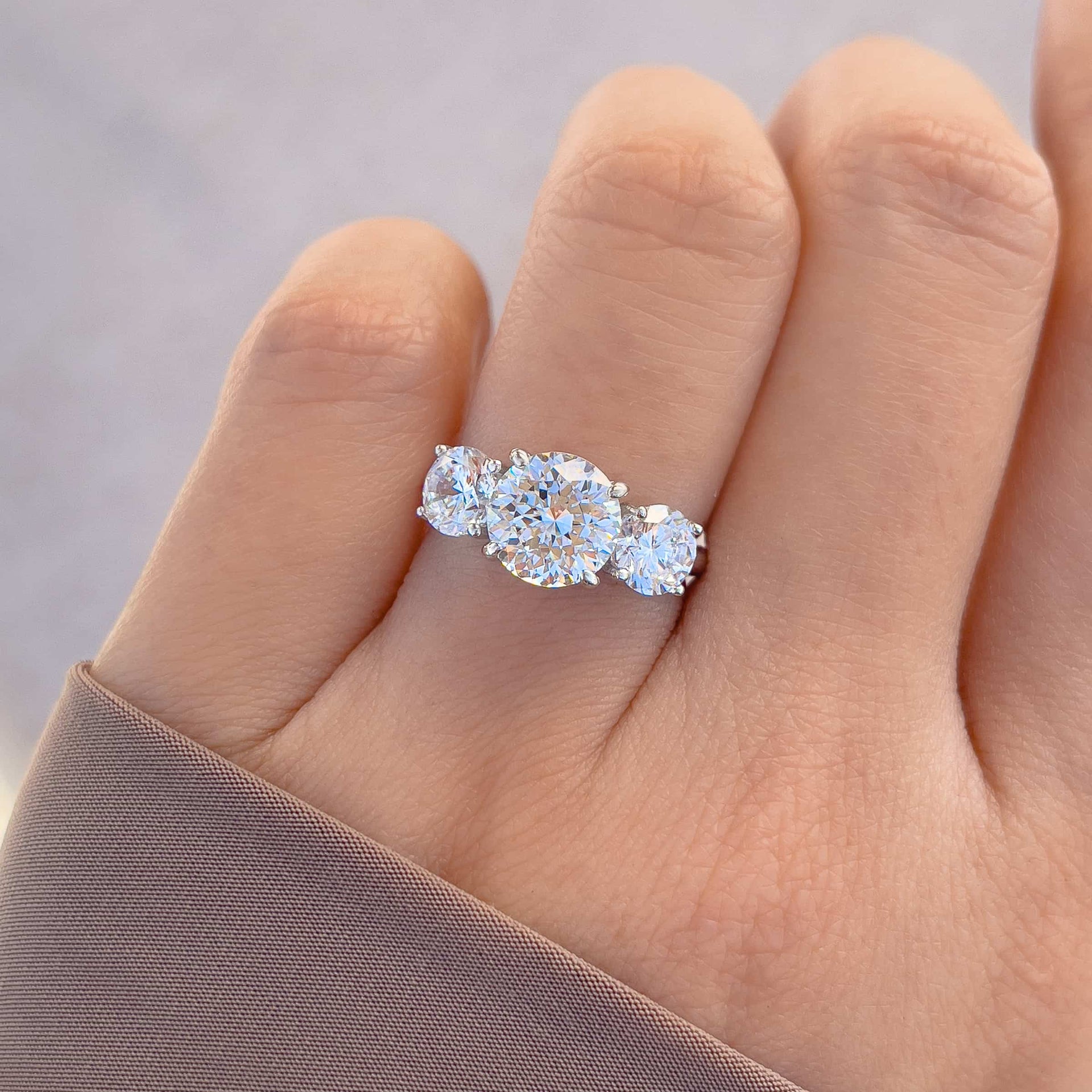 trinity 2ct silver round cut engagement ring shown on model's hand