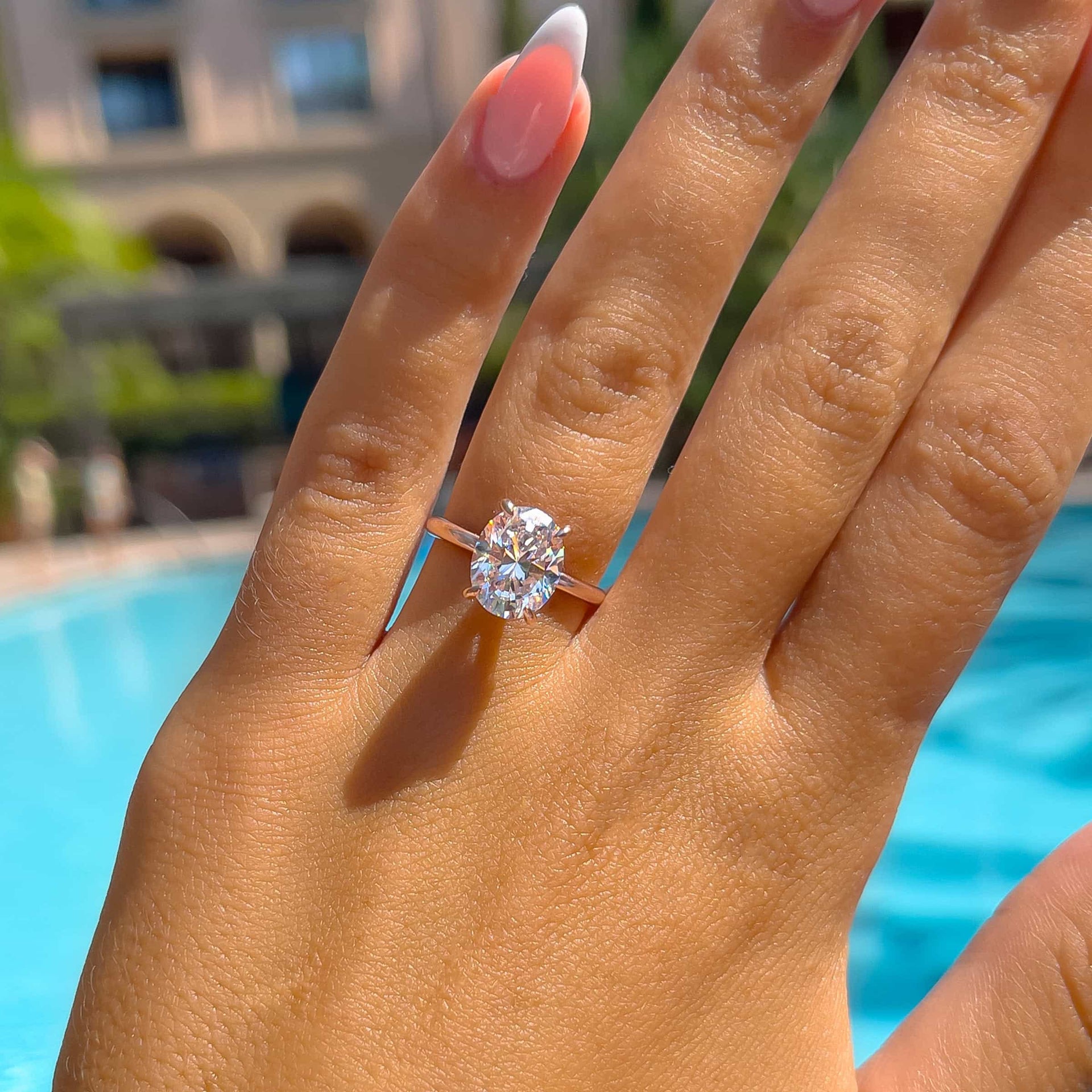 gorgeous 3 carat oval solitaire engagement ring by pool