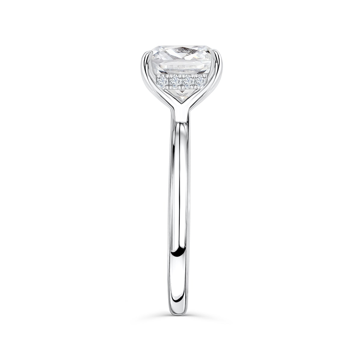Close-up side profile of The Claire silver engagement ring with cushion-cut simulated diamond solitaire and hidden halo on white background