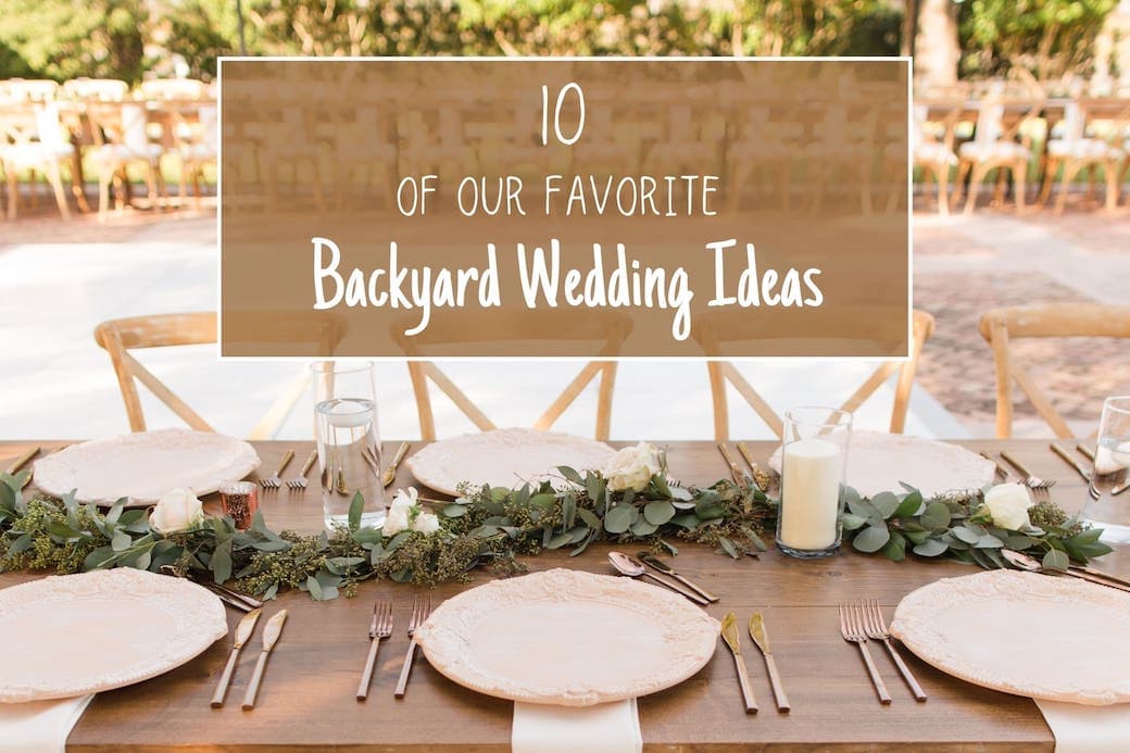 Outdoor backyard wedding reception with wooden chairs, eucalyptus garland, and string lights.