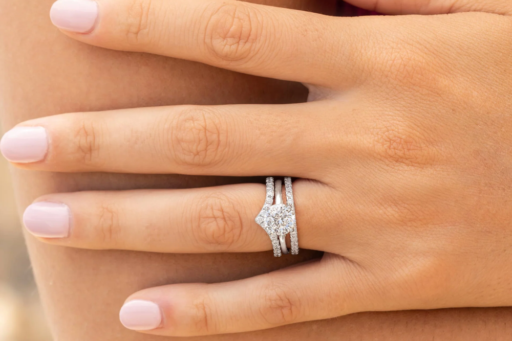 a woman wearing wedding ring stack