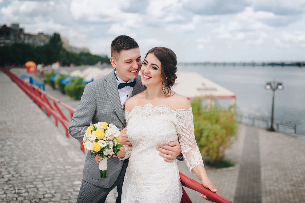 a bride and groom embracing for a photo