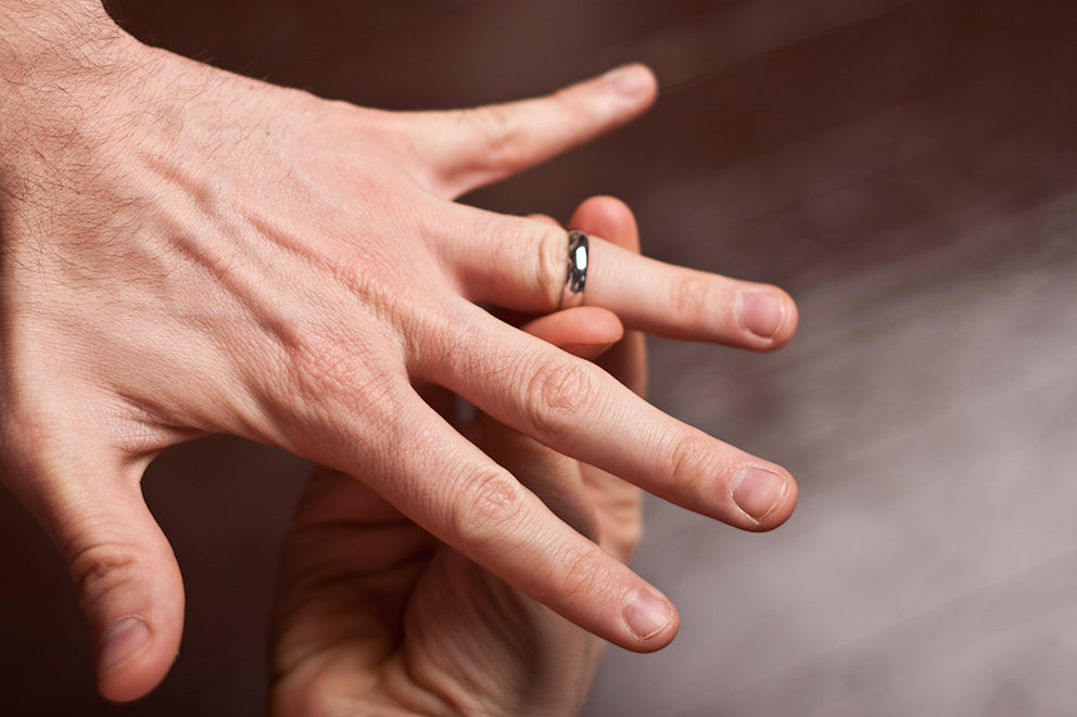 a man putting on his wedding band