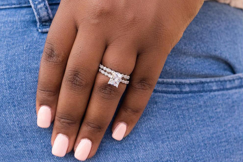 close up of a woman's hand wearing silver rings 