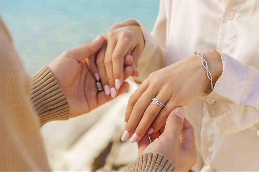 couple holding hands wearing wedding rings