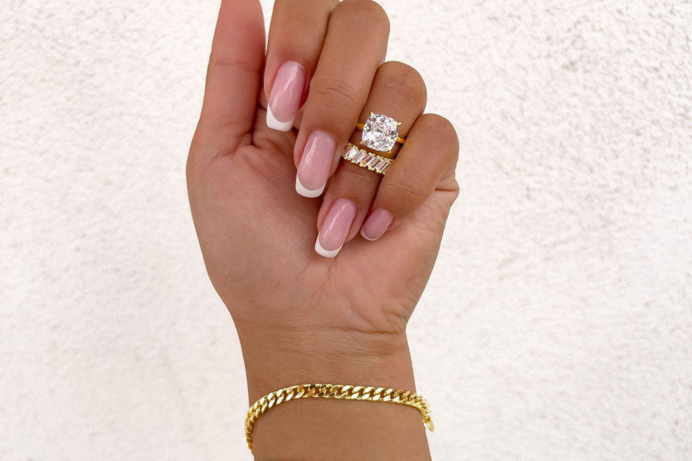 gold bracelet and rings on hand
