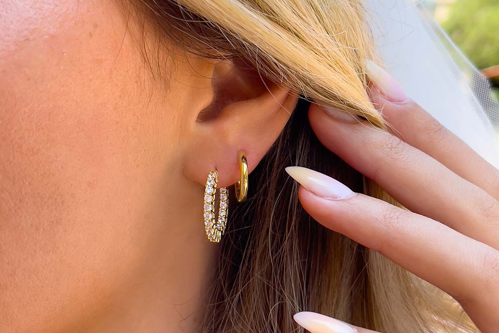 gold hoop earrings in ear