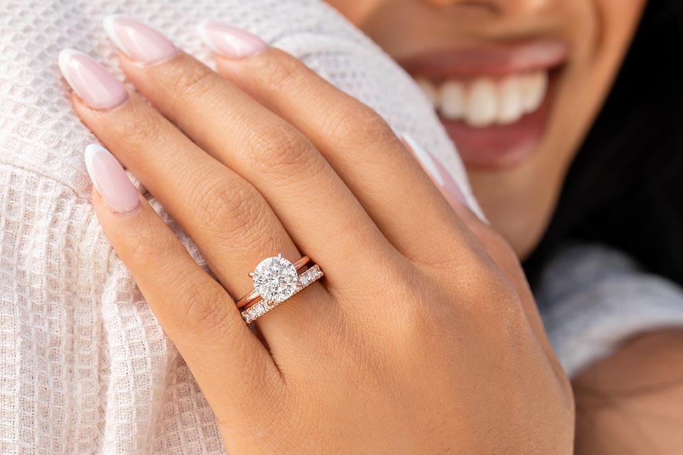 hand wearing rose gold wedding ring
