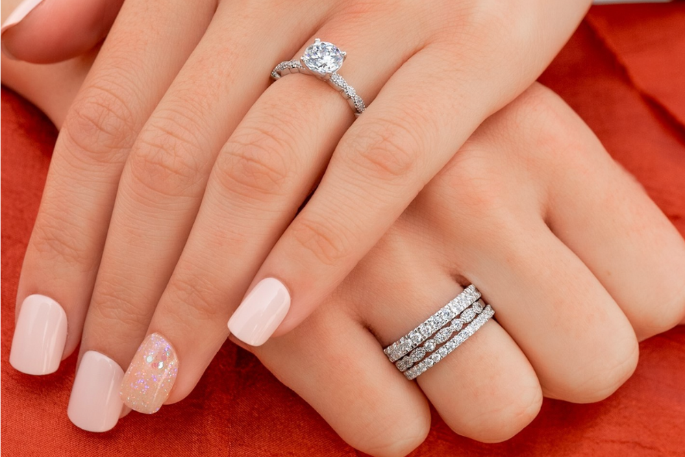 hands wearing four modern gents rings