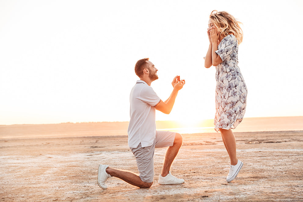 a man proposing to a woman on the beach