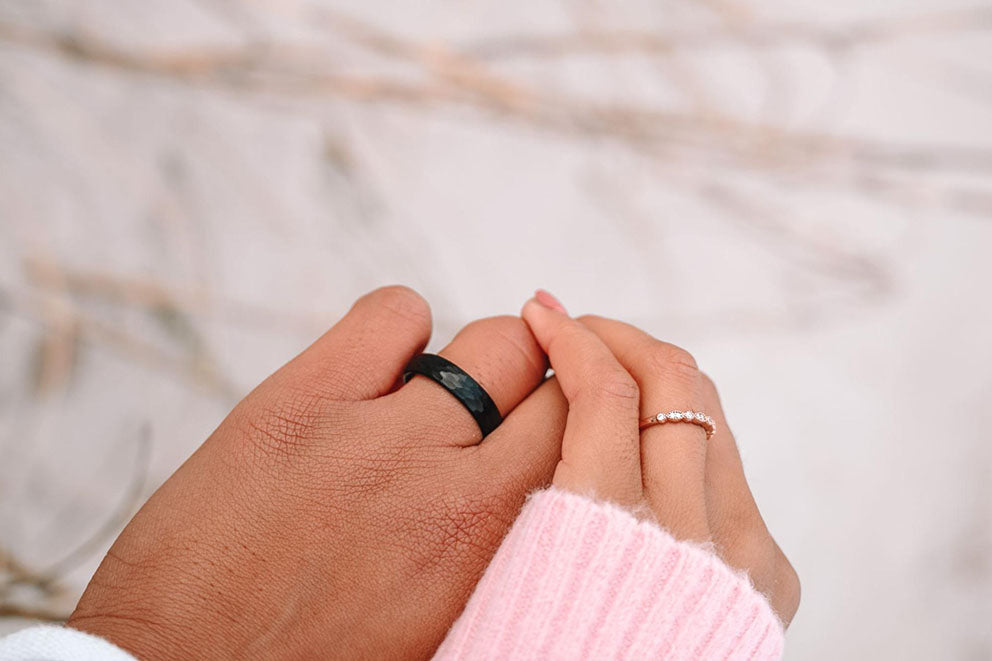 man woman pair hands wearing rings