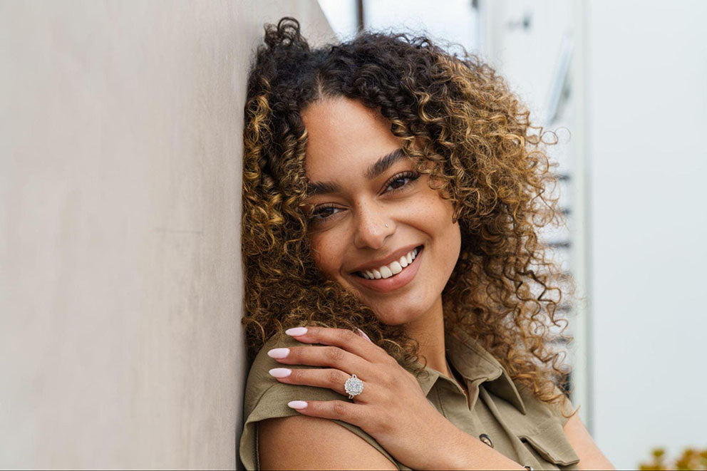 posing while wearing engagement ring