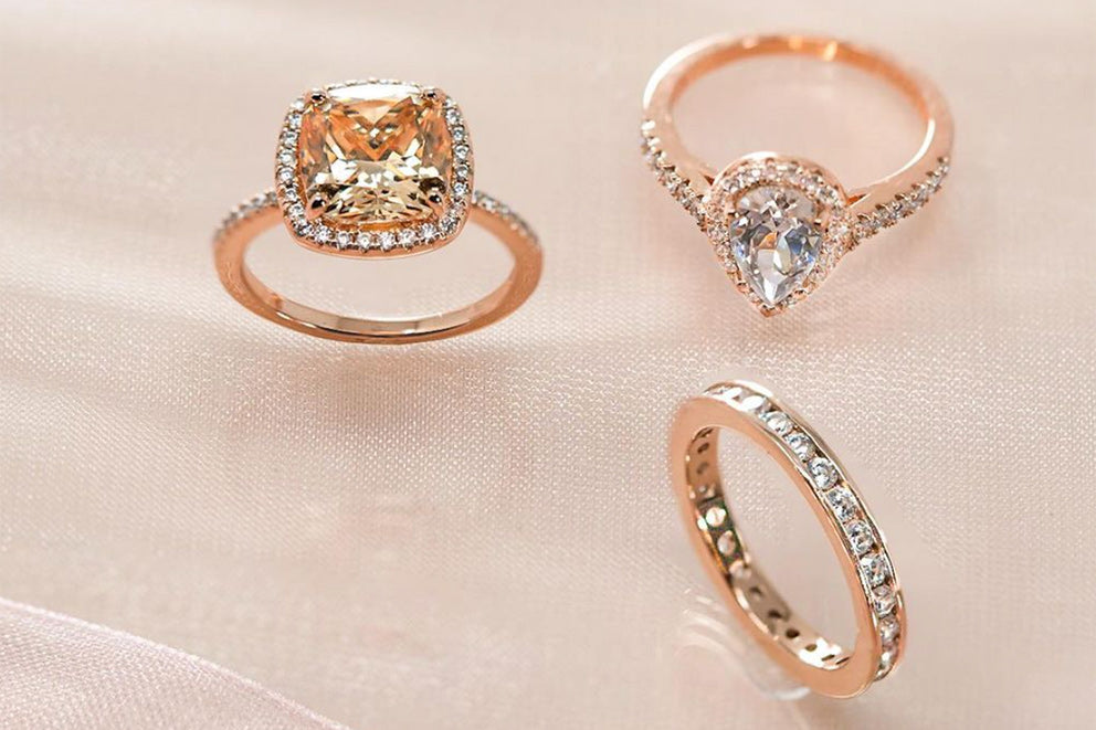 a trio of rose gold rings on display