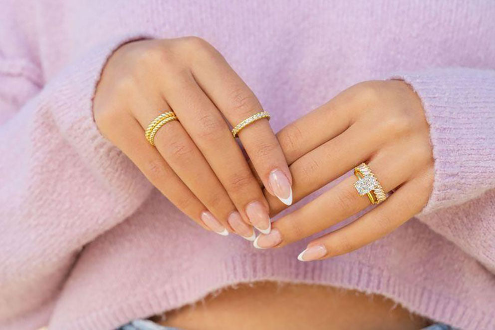 wearing multiple gold rings