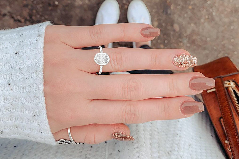 a woman wearing an oval cut ring