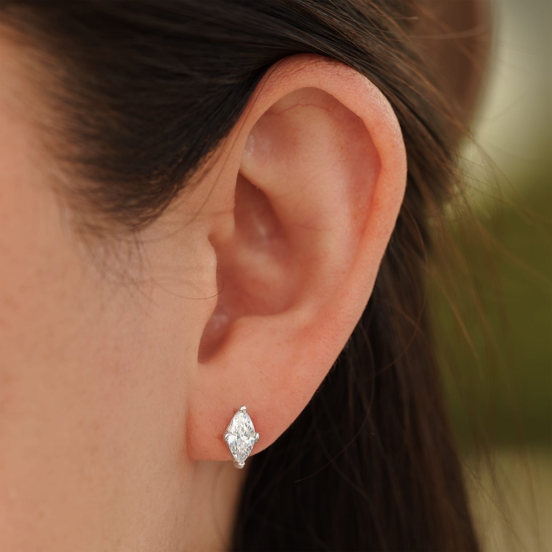 small silver marquise cut stud earrings on female model