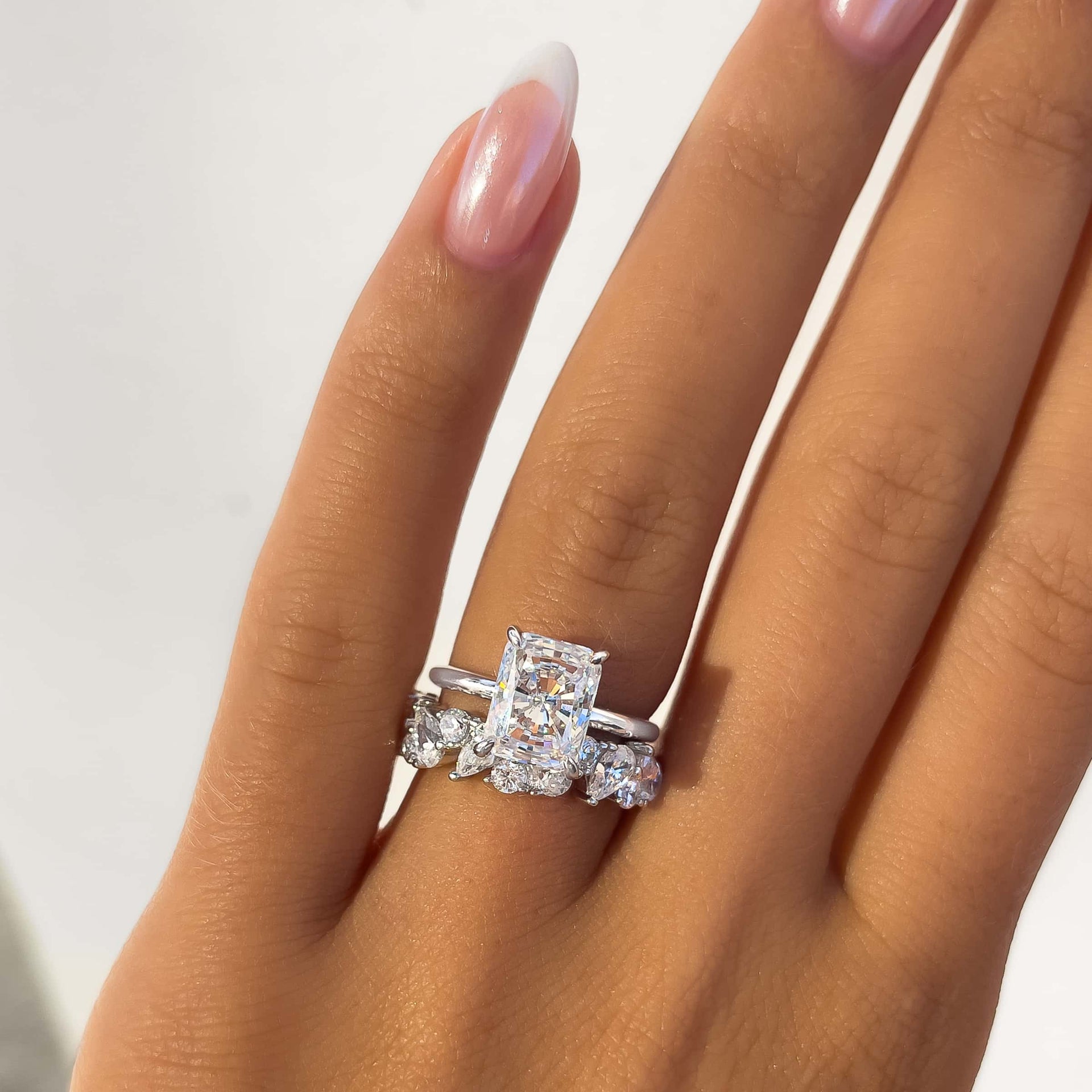 thick silver mixed cut wedding band paired with radiant cut solitaire engagement ring