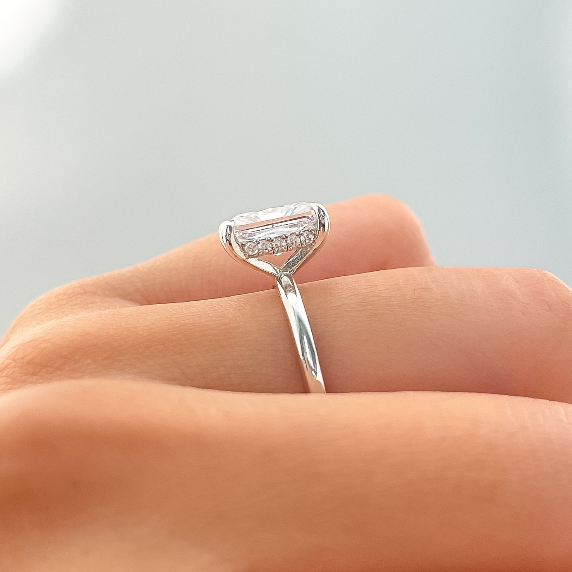 setting shot of silver radiant cut solitaire engagement ring with hidden halo