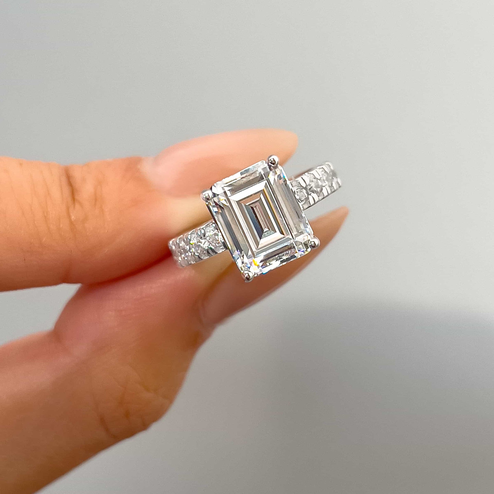 close up of silver 3.75 carat emerald cut engagement half eternity ring