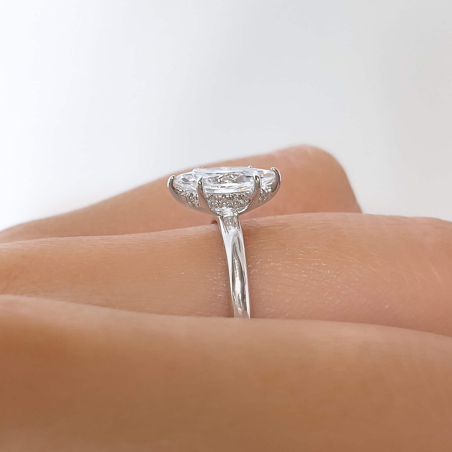 Side profile of 1 carat marquise cut solitaire ring with hidden halo