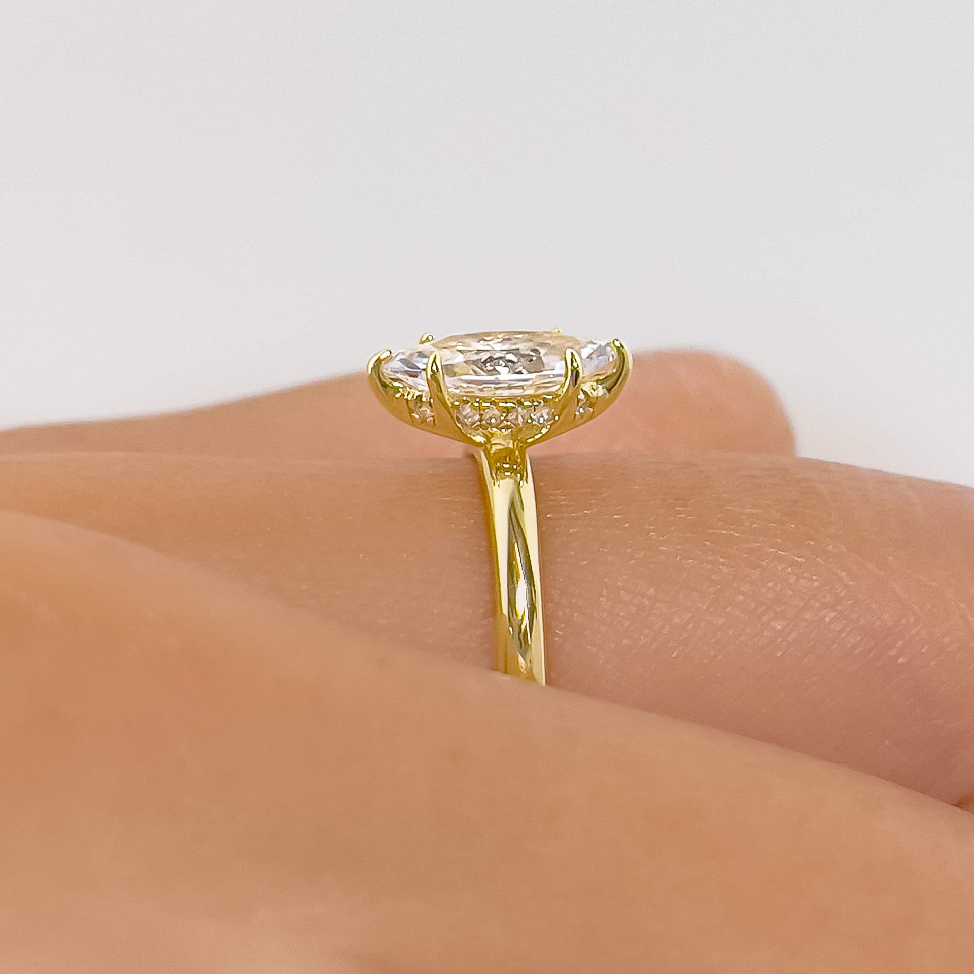 Side profile of 1 carat marquise cut solitaire ring with hidden halo