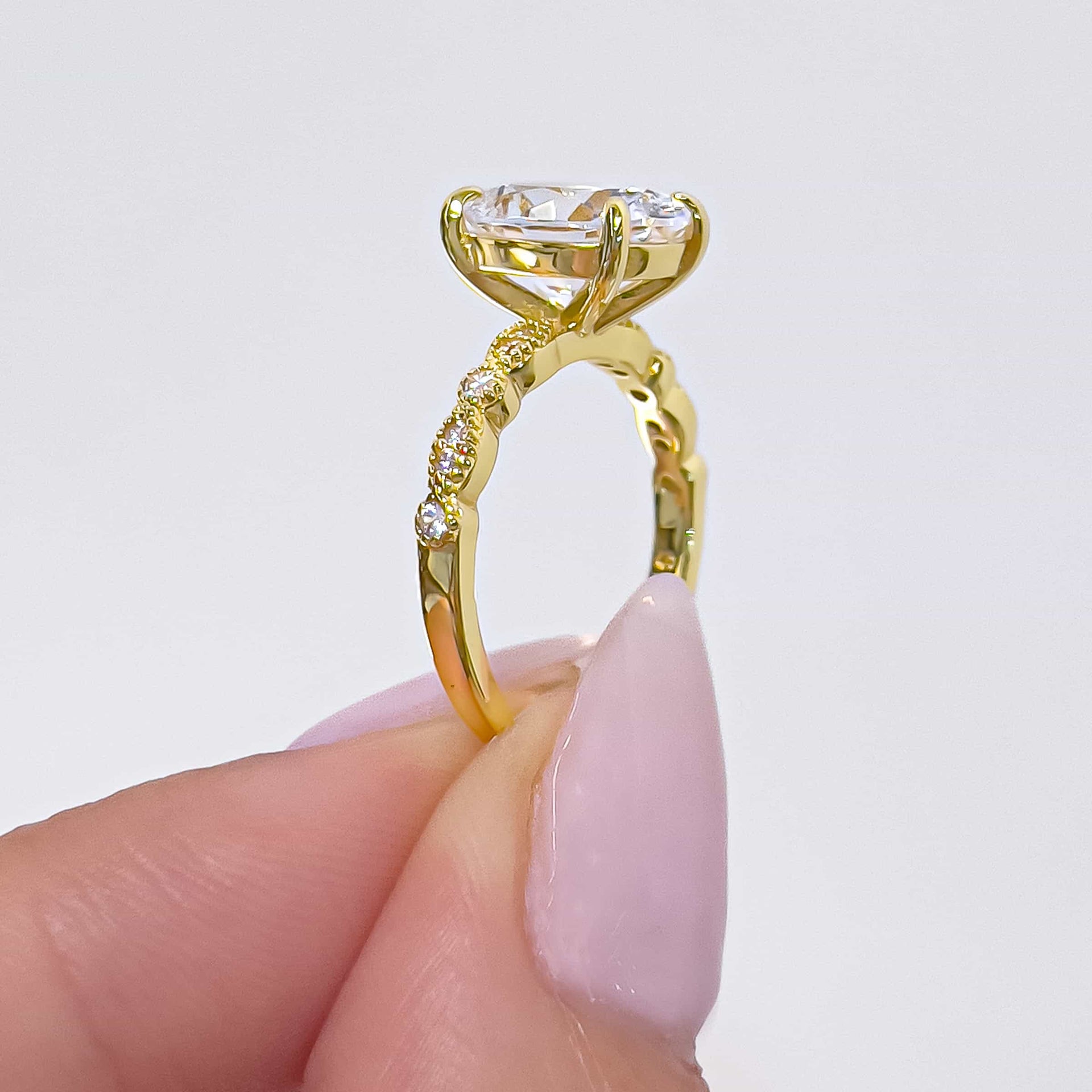 setting shot of gold oval cut engagement ring with vintage detailing