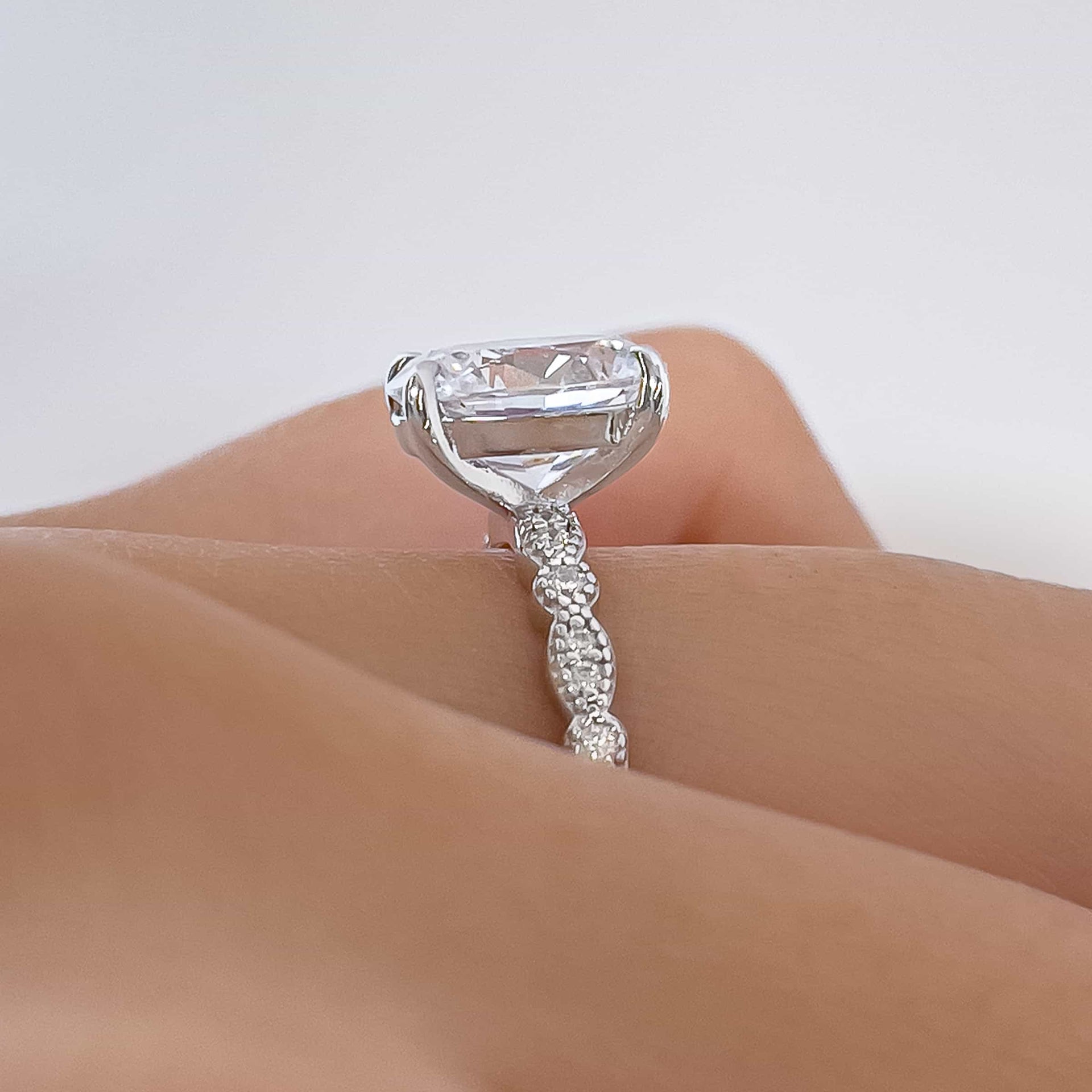 setting shot of silver oval cut engagement ring with vintage detailing