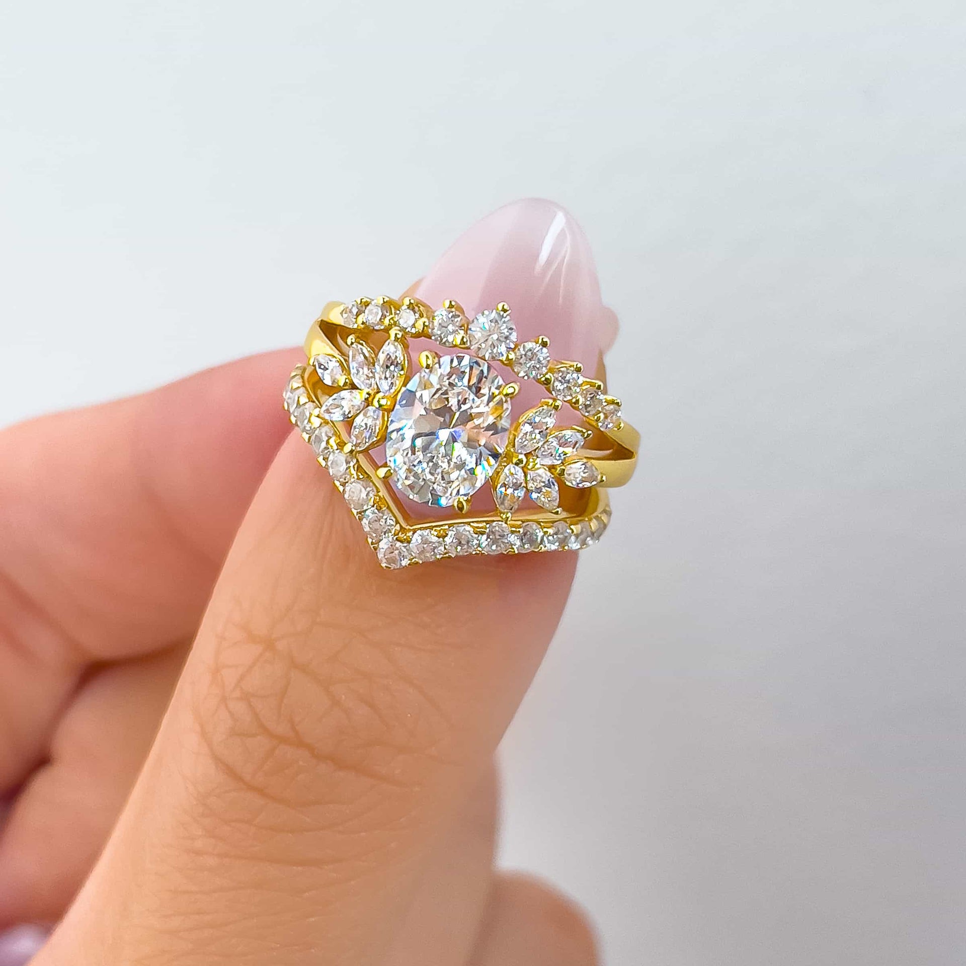 unique and vintage gold wedding ring set on model with light pink nails