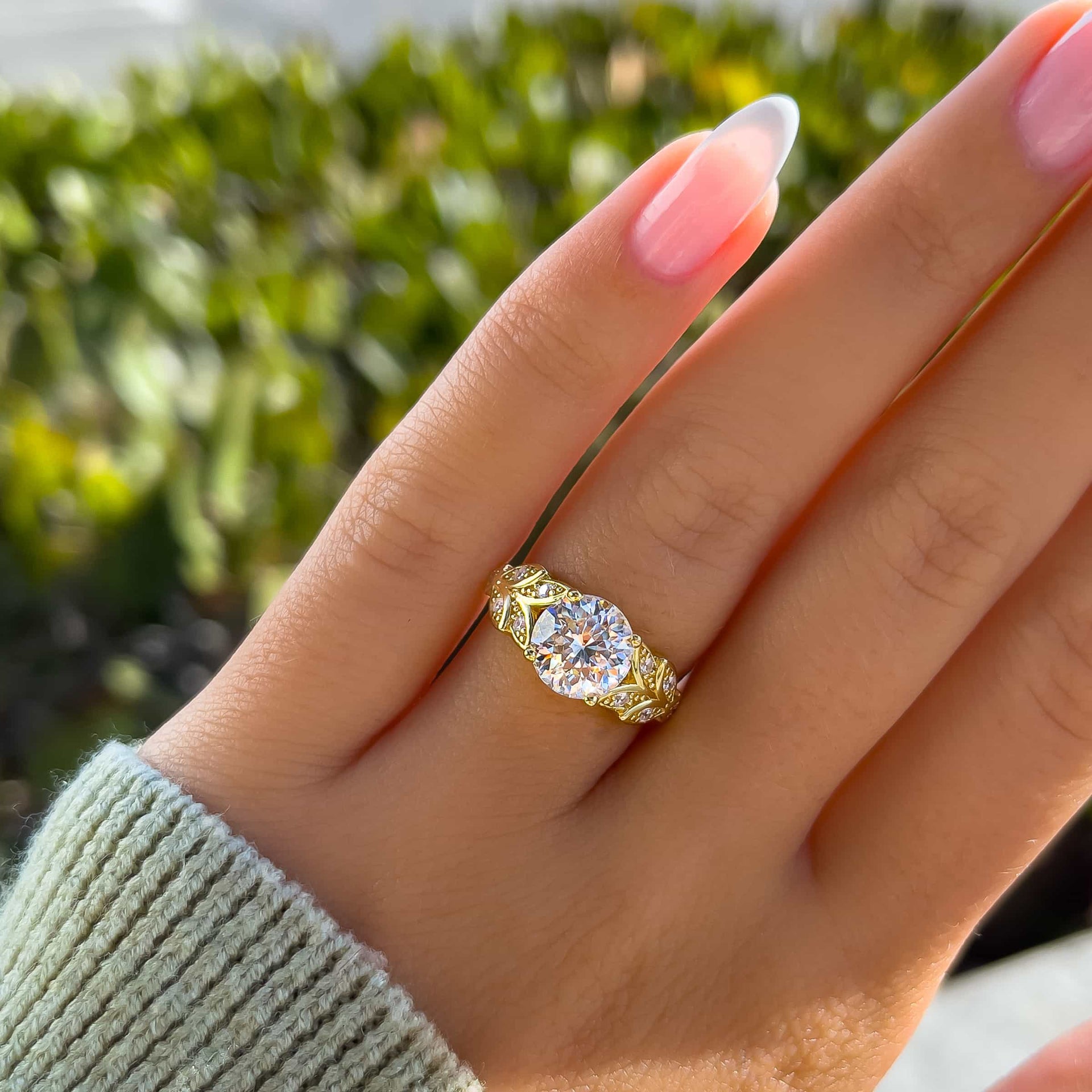 stunning 2 carat round cut engagement ring on model with green sweater