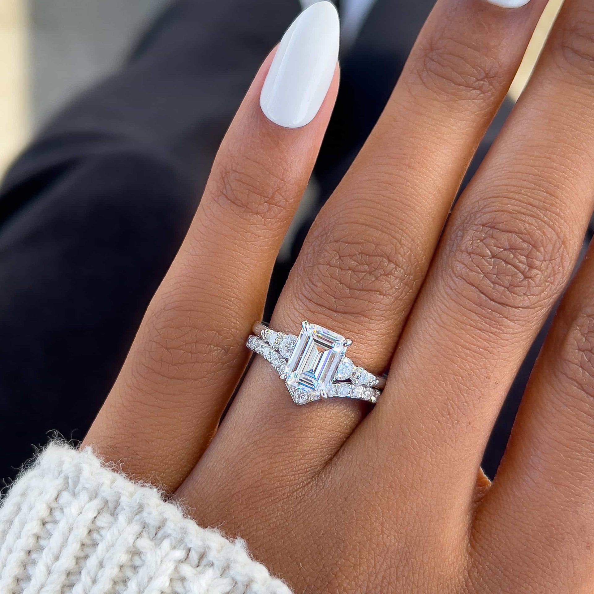 sparkling silver wedding ring set made of emerald cut engagement ring and chevron style engagement ring