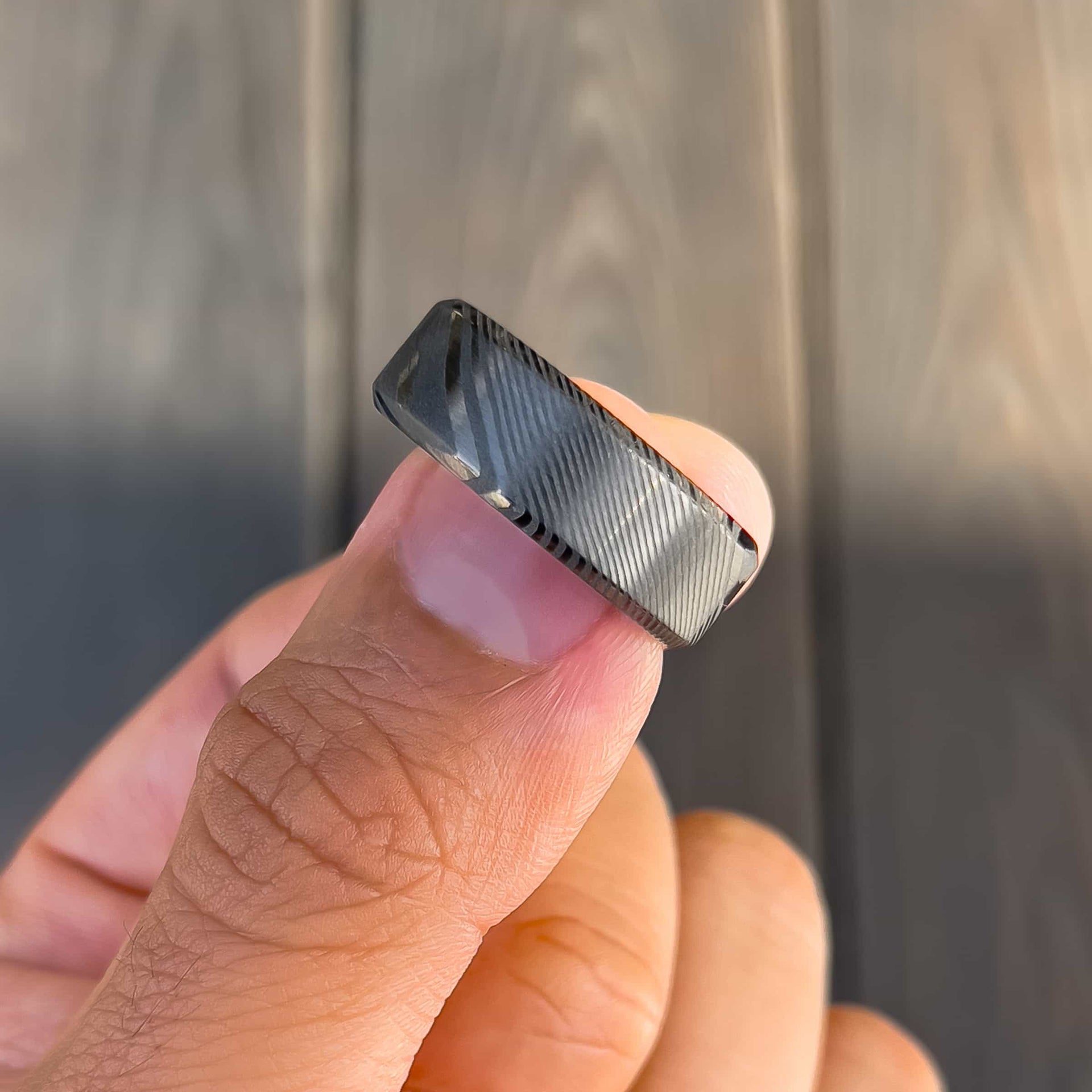 stuunning slate colored mens wedding ring shown on man's finger