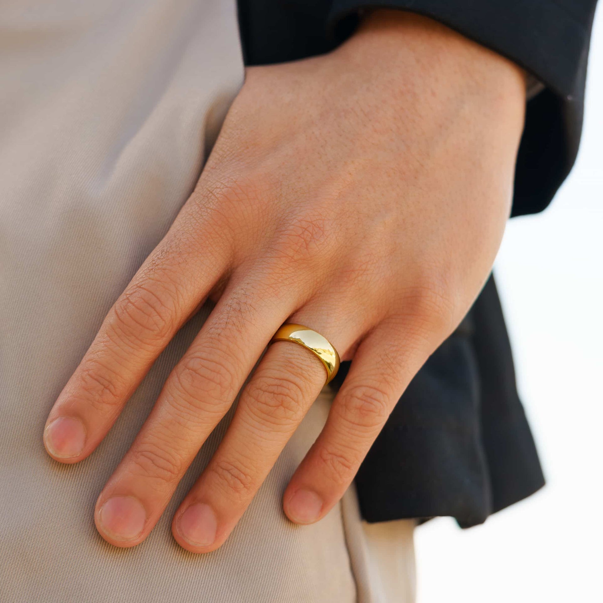 affordable gold unisex Horizon wedding ring shown on a man's hand