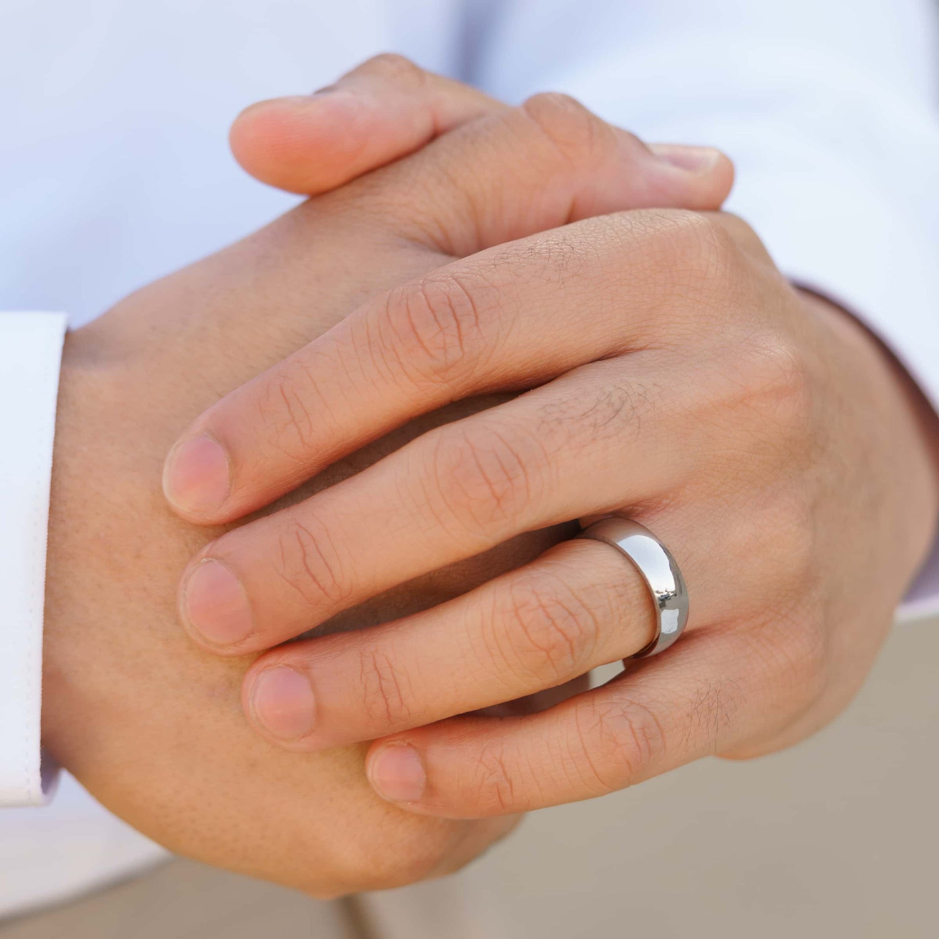 affordable silver mens Horizon wedding ring on model's hand with white shirt