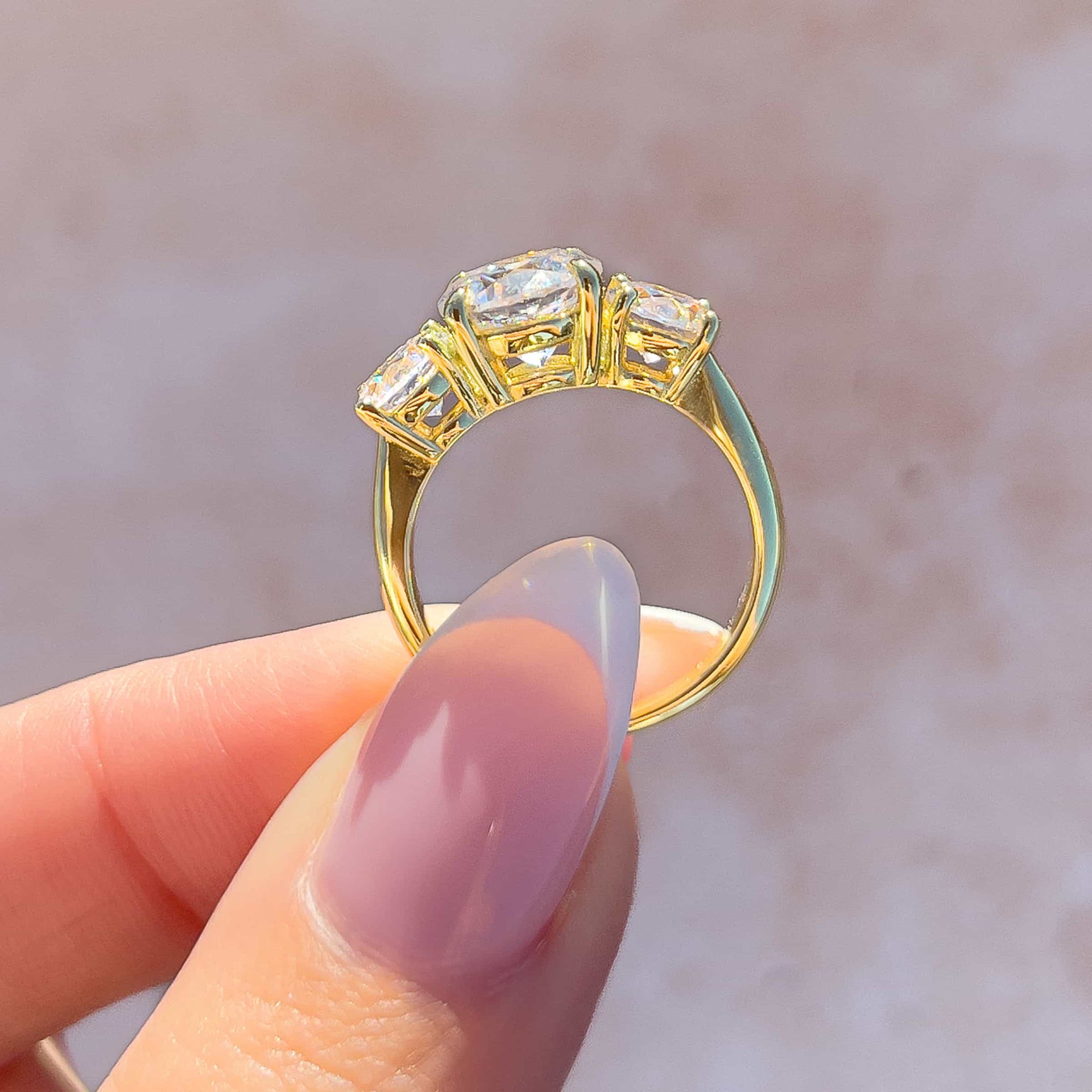 stunning side angle of the trinity 2ct gold round cut engagement ring