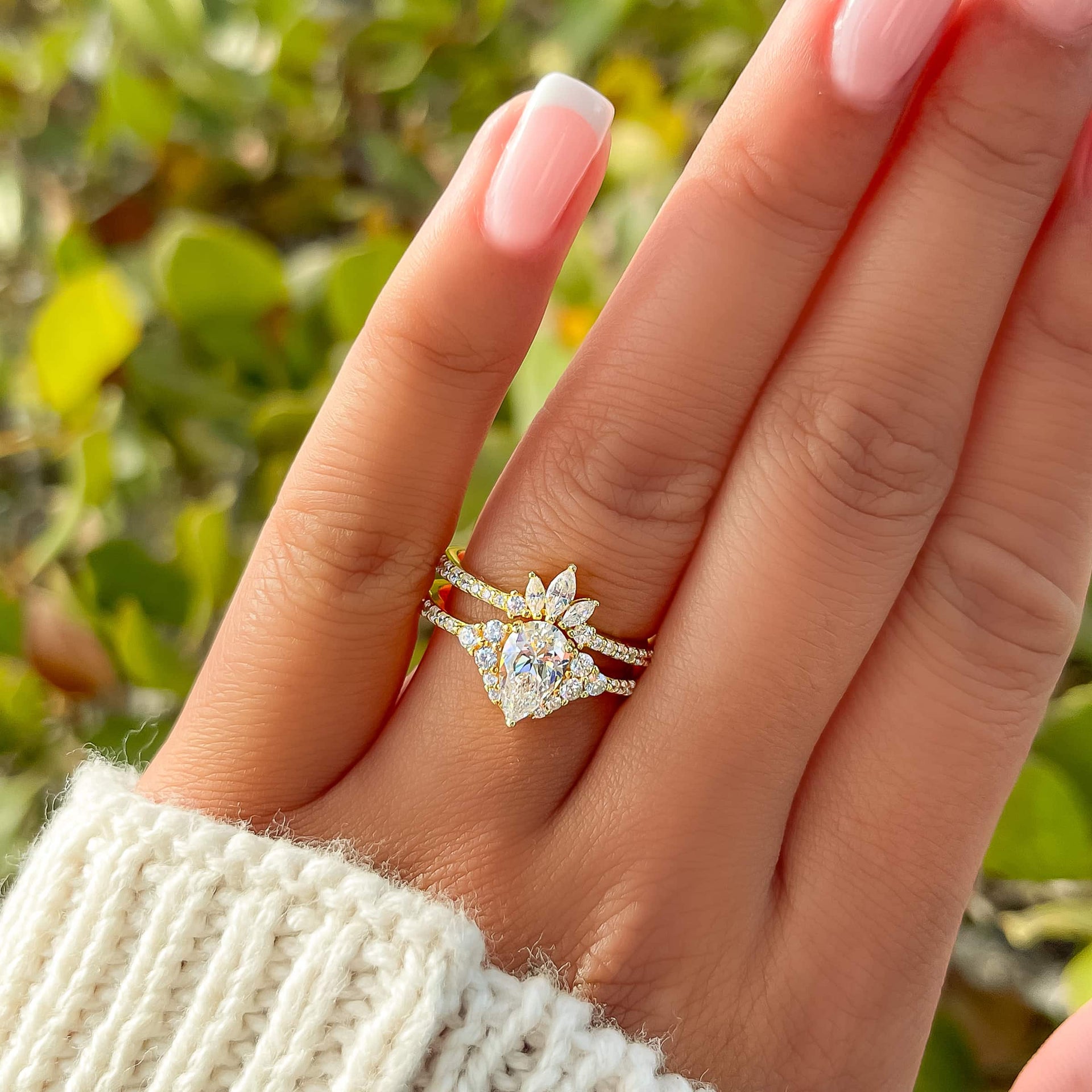 Stunning and unique gold vintage wedding ring set on model with french tips and a white sweater