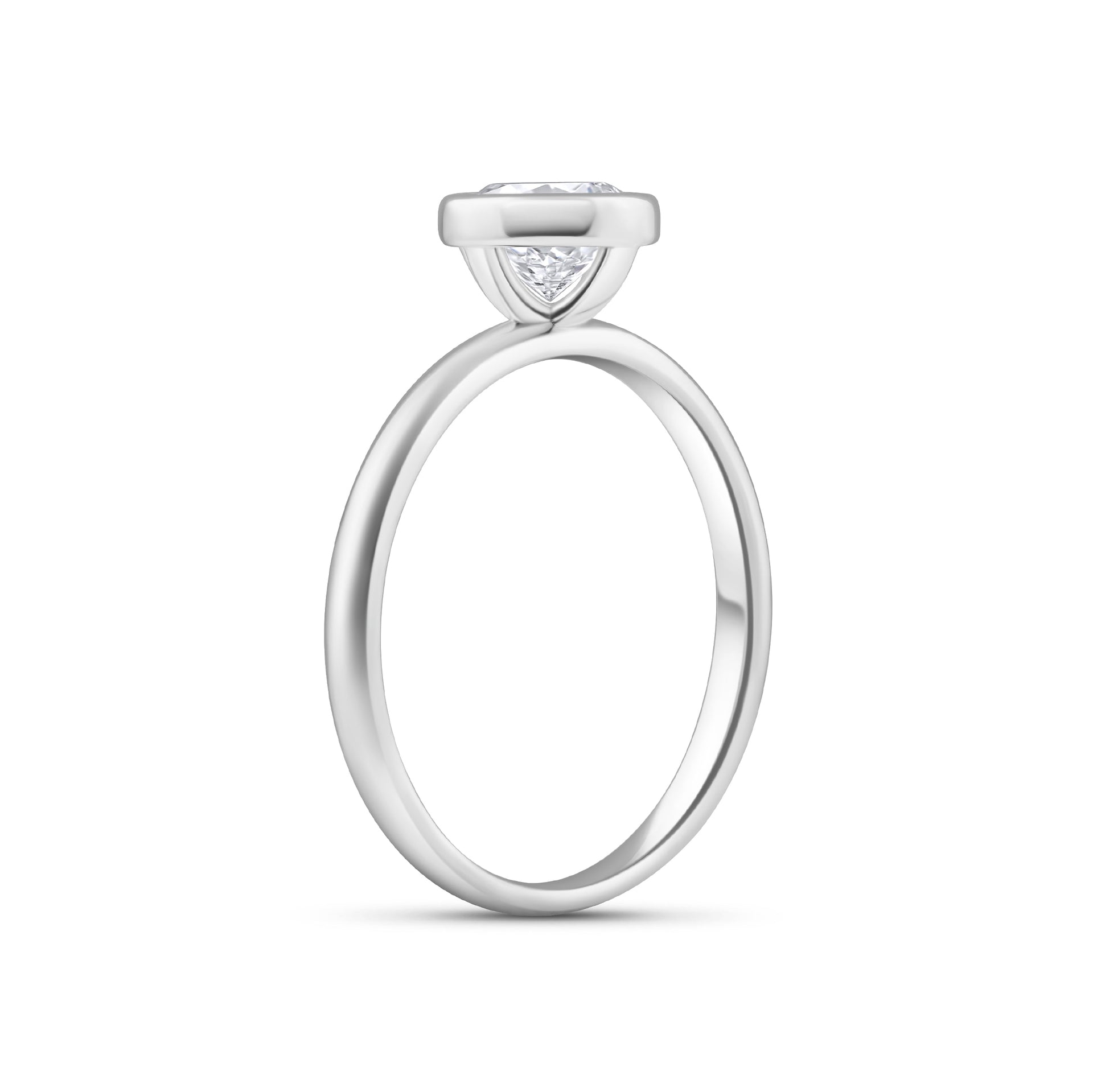 silver engagement ring with 1.25 carat round cut stone in a bezel setting on white background