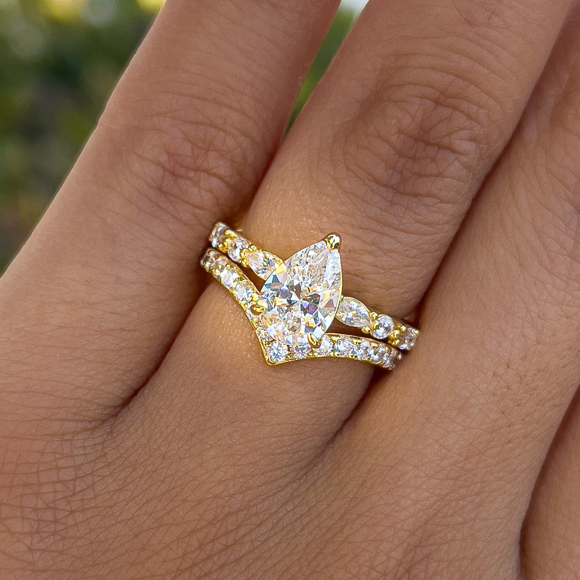 unique gold half eternity pear cut wedding ring set worn by female model
