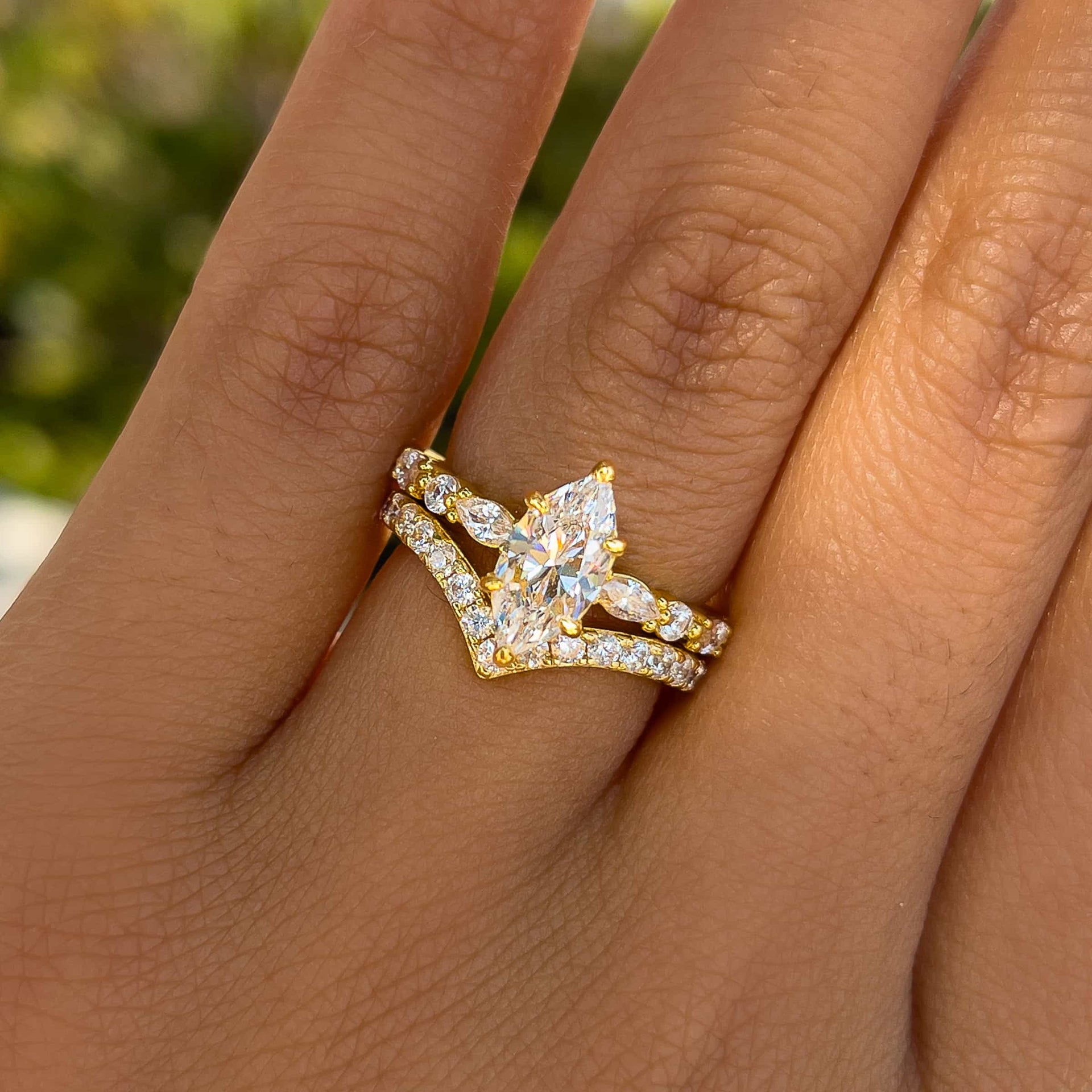 unique gold marquise cut wedding ring set on female model