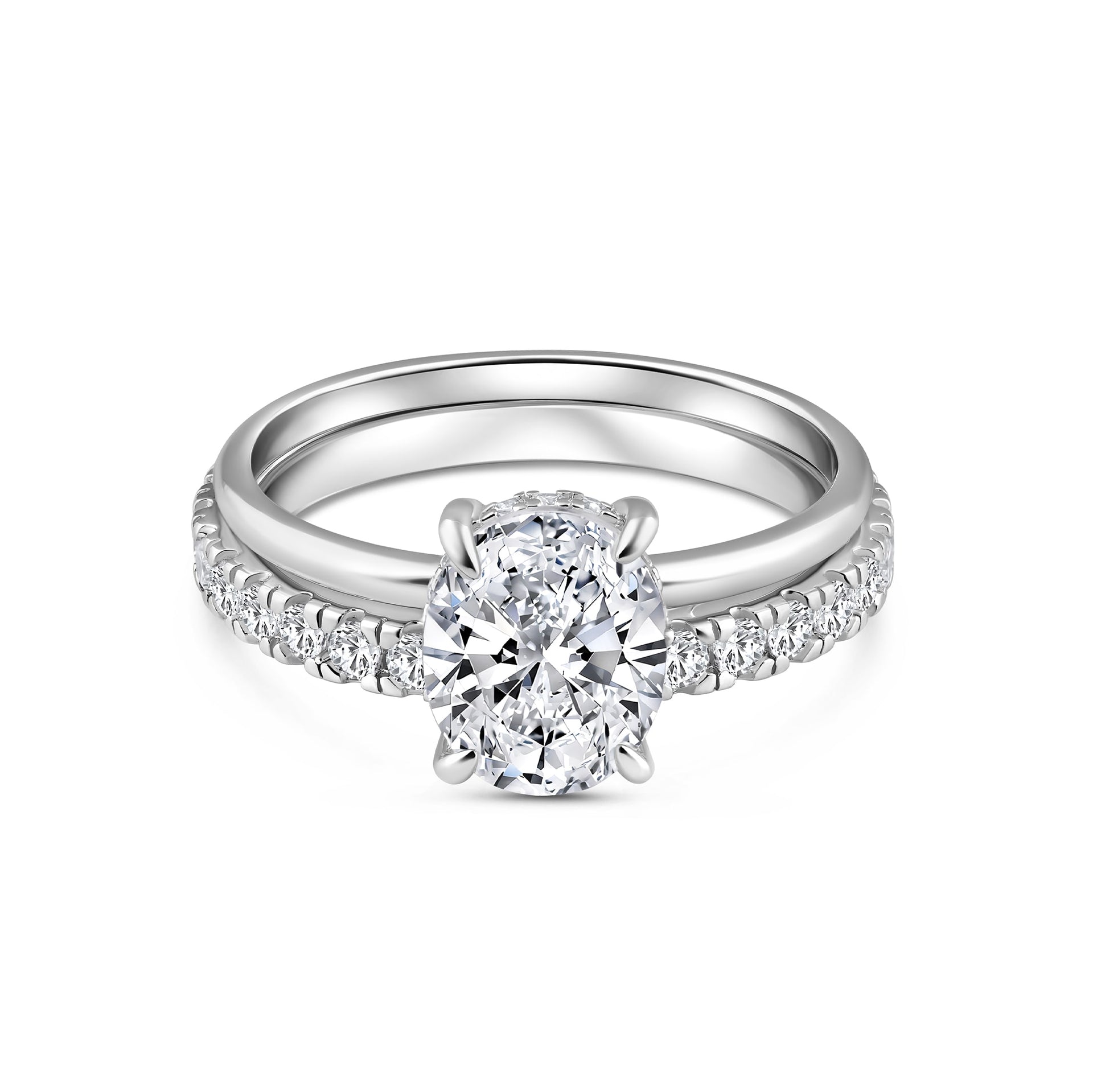 classic silver 3 carat oval cut wedding ring set with solitaire engagement ring and full eternity wedding band on a white background