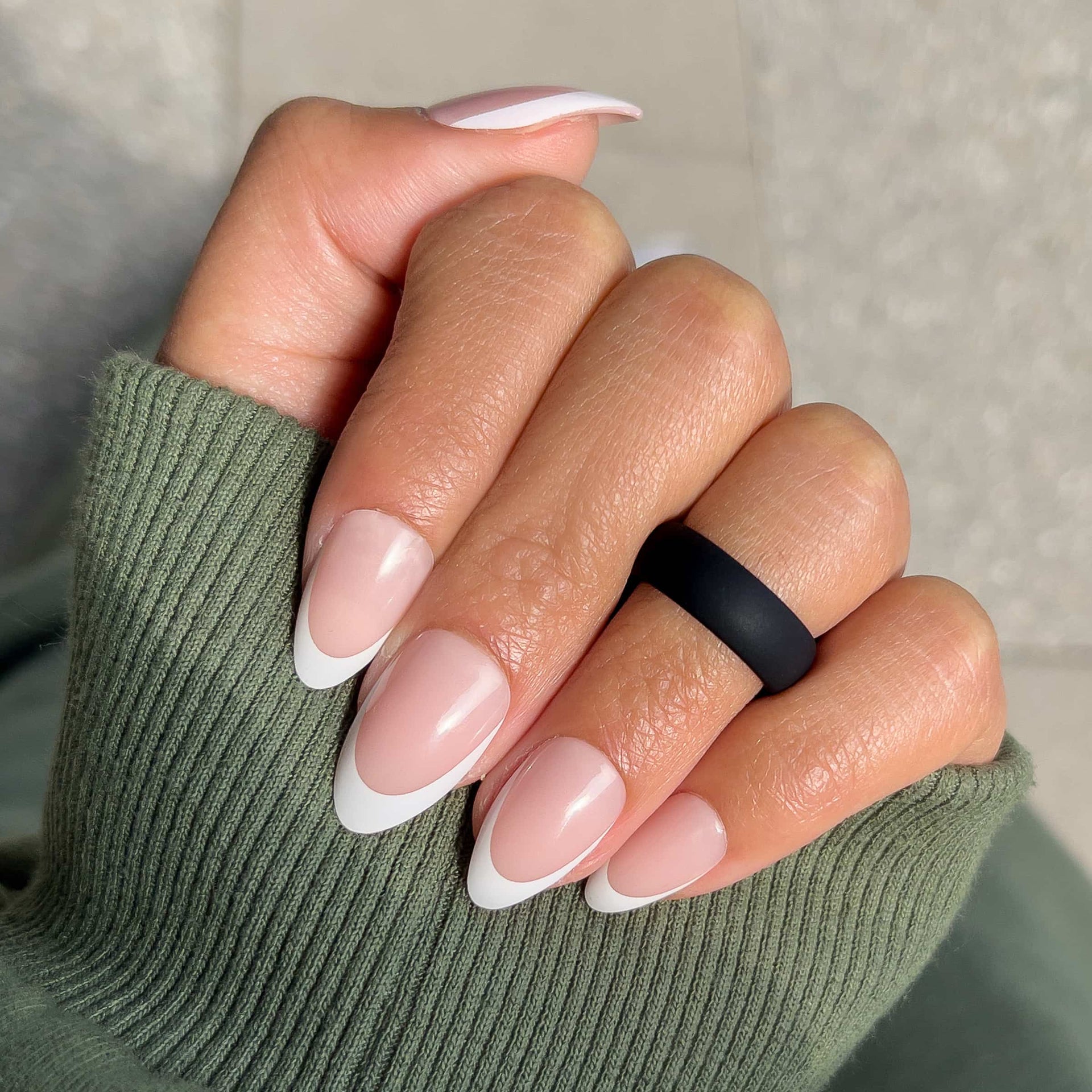 black silicone alternative band worn by model with unique french tip nails